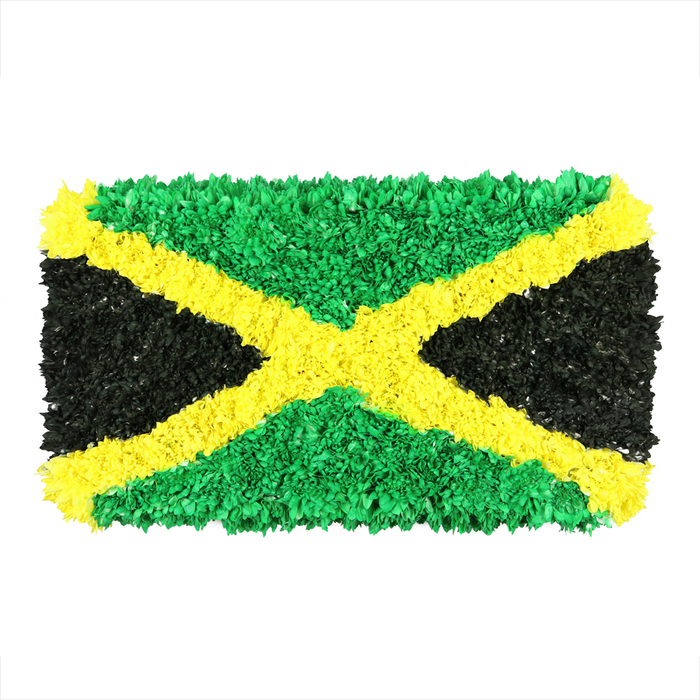 An eye-opening, vibrant interpretation of the Jamaican flag, built from densely packed, small crinkled pieces of material-predominantly recycled paper, fabric scraps, and other salvaged textures-giving the surface a rich, tactile depth. The bold gold saltire cuts diagonally across the rectangle, connecting opposite corners and dividing the surface into four distinct triangles. The top and bottom triangles glow in emerald green, their many little fragments catching a spectrum of greens as they shift in the light. The left and right triangles render a deep, matte black, crafted from countless speckled slivers that create a velvet-like glow. The overall effect is a handcrafted mosaic with visible, inviting irregularities, a testament to patient technique and sustainable craft. Displayed on a clean white background, the piece reads as a contemporary sculpture that still carries warmth and memory, a perfect anchor for discussions of national identity, sustainability, or community art projects. In our Stanmore studio, the work's texture invites touch and conversation, and its color story echoes the lush hills and sunlit shores of Jamaica while remaining deeply rooted in northwest London's culture. It would complement features about Jamaican heritage, local art initiatives, or creative expressions within the Canons Park corridor. Crafted here, by hands from our community, it travels well for exhibitions or tributes, reinforcing how reuse and artistry can travel together, much like our flowers do for same-day deliveries to Stanmore and nearby neighborhoods.