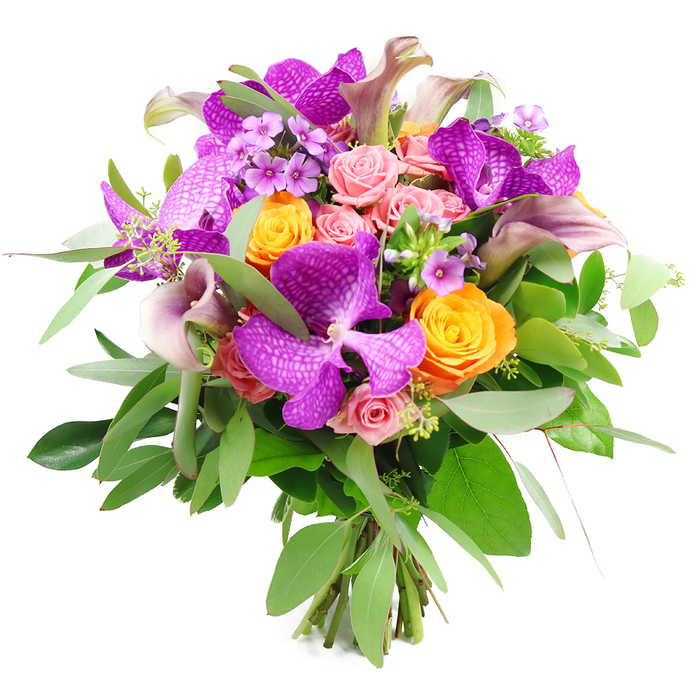This sophisticated bouquet is captured against a pure white background, its rounded form and intricate mixture of blooms giving it a quietly luxurious presence, perfect for a Stanmore living room or hallway console. Dominating the composition are several large Vanda orchids in an intense fuchsia-purple shade, their velvety petals patterned with a delicate, speckled network that lends each flower an artful, almost hand-painted look. Interwoven among these exotic blooms are vibrant orange roses, firmly cupped and tightly spiralled, their petals glowing in sunny tangerine tones that brighten the entire arrangement. Gentle blush-pink roses nestle between them, some still in bud and others opening into soft, layered rosettes, adding romance and a suggestion of sweet fragrance.   

Tall, elegant calla lilies emerge gracefully from the bouquet, shaded in muted lavender, mauve, and plum. Their sleek, trumpet-shaped blooms arc gently above the rounder flowers, echoing the refined silhouettes seen in the gardens around Stanmore Hill. Smaller lavender and lilac filler flowers tuck into the spaces between the larger blossoms, creating subtle flecks of purple that add intricacy and a sense of depth. A lush ring of greenery, including long, silvery eucalyptus leaves and darker, glossy foliage, surrounds the bouquet, giving it structure, cool contrast, and a natural freshness that feels like a breath of air from Stanmore Country Park.   

At the base, the stems are neatly gathered and visible, clearly tied in a classic hand-tied style that demonstrates professional skill and thoughtful design. The bouquet overall radiates celebration and tenderness, ideal as a refined anniversary gift delivered to homes around Belmont Circle, a statement piece for a dinner near Marsh Lane, or a meaningful thank-you gesture sent across Stanmore, where same-day delivery keeps the blooms at their most vibrant and fresh.