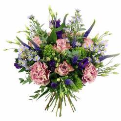 This image shows a beautifully balanced floral bouquet set against a clean white backdrop, its colours and textures evoking the calm, leafy character of Stanmore. The design is hand-tied and rounded, with a gentle dome shape that feels abundant without being overwhelming. At the centre are pastel pink roses, their petals unfurling in graceful spirals. Some are already fully open, revealing intricate layers that fade from a warmer pink core to soft, creamy outer edges, while others remain half-closed, adding a sense of quiet anticipation. Tucked between the roses, generously ruffled carnations appear in tones of dusty rose and mauve, their full, frilly petals creating a plush, tactile richness. Rising through the bouquet, slender spires of deep blue-violet Veronica bring height and contrast; their linear form and saturated colour add a touch of drama, a little like the striking views you catch from Stanmore Common on a clear day. Scattered throughout the arrangement are light, daisy-like asters, each flower with soft lavender or periwinkle petals and a tiny yellow centre. They form a gentle, cloud-like veil that lightens the overall effect. Accents of deeper purple come from lisianthus blooms, some open and some still budding, adding a layered depth to the palette. Around the blooms, a collar of mixed foliage-silvery eucalyptus leaves, bright lime-green clusters of textural filler that may be sedum or green trick carnations, and other fresh greenery-provides structure and a vibrant contrast to the softer flower tones. The stems at the base are gathered tightly and cut neatly, emphasising the craftsmanship of a skilled florist familiar with Stanmore's tastes. The mood of the bouquet is one of refined celebration and tender sentiment, perfectly suited to picture as a delivery for an anniversary dinner, a special birthday, or a comforting gesture sent across the HA7 area.