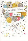 The scene presents a beautifully designed congratulations card, positioned upright so that its front becomes the main focus. A generous cluster of illustrated balloons dominates the design, rising from the lower portion and gently drifting upward in a loose, organic grouping that resembles a buoyant bouquet. The balloons are coloured in a harmonious mix of metallic gold, soft silver, champagne, powder blue, blush pink, and misty grey, with each one embellished by tiny stars, shimmering speckles, fine stripes, or subtle dot patterns that create the impression of light glancing off their surfaces. Their delicate strings, drawn in gleaming lines of gold and silver, sweep downwards in relaxed, curling movements, intertwining in much the same way as ribbon cascading from a freshly tied arrangement prepared for delivery around Stanmore. All around this central cluster, small stars and curving streamers scatter across a pale, understated background, suggesting confetti and party ribbons caught mid-air just after a big announcement. Floating calmly through the centre, a white, ribbon-like banner curves across the balloons and carries the message Congratulations To You in an elegant, flowing script that feels warm, sincere, and slightly celebratory without being loud. The overall atmosphere is one of joyful sophistication, the kind of card you could imagine propped beside a vase of flowers on a sideboard near Stanmore Broadway, or handed over after a family celebration close to Canons Park. It captures the lightness and pride of special moments-new jobs, graduations, anniversaries of achievements-when you want to wrap your congratulations in something visually uplifting and beautifully composed.