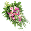 This elegant funeral spray is photographed on a clean white background, its form sweeping diagonally from a full, rounded cluster at the upper left to a gentle taper at the lower right, like a floral echo of a bowed head in remembrance. The arrangement combines a soothing blend of pastel pink, deep fuchsia, soft purple, and crisp white flowers, all resting in a cradle of rich green foliage. At the visual centre, several large gerbera daisies bloom in shades of blush and vivid magenta, their finely textured petals radiating out from dark centres, lending the piece both brightness and structure. Interspersed with them are classic pink roses, their velvety, spiralled petals unfolding with understated grace. Nestled among these main blossoms are fluffy white flowers that resemble miniature carnations or small chrysanthemums, adding a plush, tactile softness, while light sprays of tiny white daisy-like flowers weave between them, recalling the gentle simplicity of wild blooms along Stanmore's residential garden paths. Bright red hypericum berries are placed carefully throughout, offering glossy, bead-like points of interest that lead the eye along the diagonal line of the design. The flowers are supported by a generous base of foliage, including broad, glossy dark green leaves, airy fern fronds that soften the edges, and rounded eucalyptus leaves in silvery green that suggest a cool, refreshing fragrance. From the lower right, long, narrow palm leaves extend outward, emphasising the cascading movement and adding a graceful finish. At the upper left, the securely bound stems are partially visible, revealing the careful hand-tied craftsmanship behind the arrangement. Suitable for services in Stanmore's churches, crematoria, or chapels, this tribute conveys a quiet message of affection, peace, and lasting respect for the person being remembered.